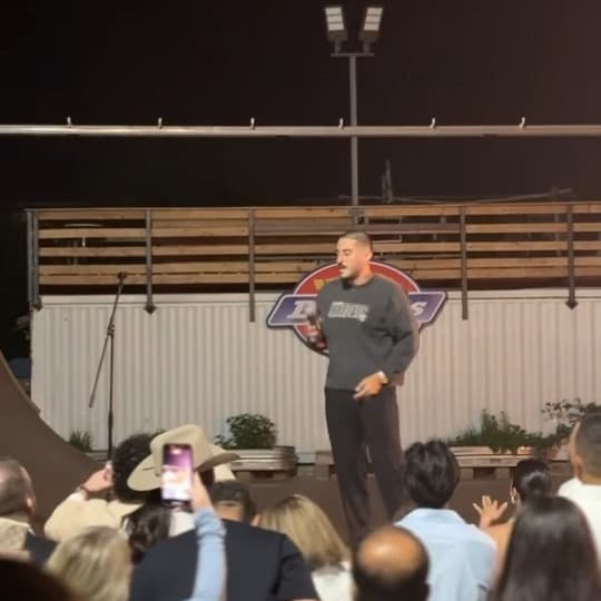 Founder Parsa Bastami addressing the crowd at night during Pulse of the People